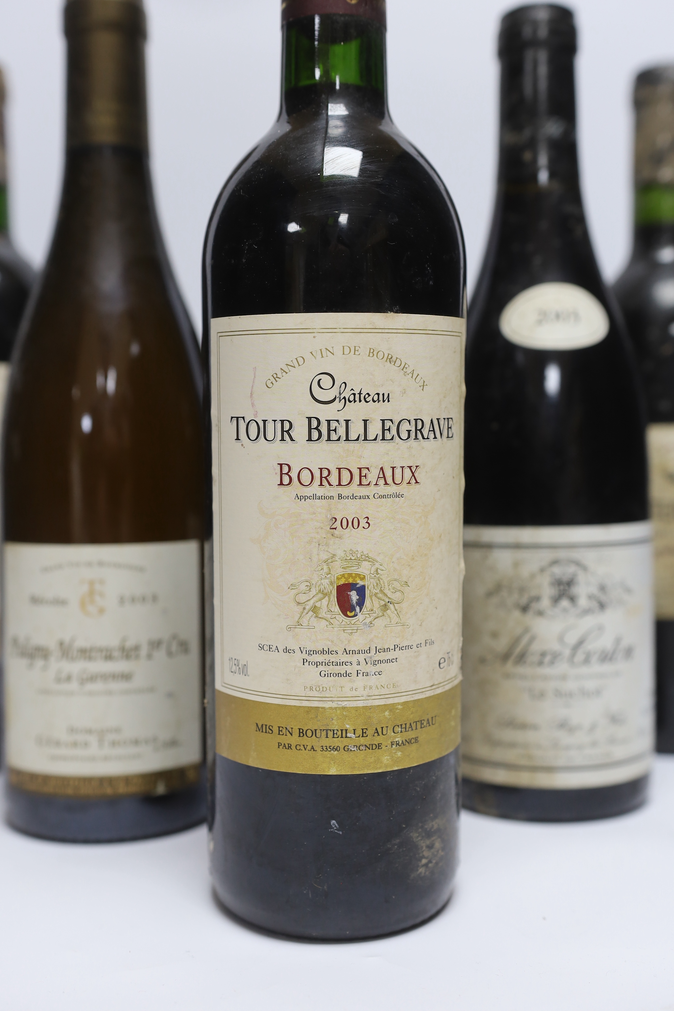 Six bottles of red wine - two bottles of Chateau Tour Bellegrave 2003, a bottle of Baron De Ley Rioja, a bottle of Simon Bize Aloxe Corton Le Suchot 2003, a bottle of Gérard Thomas Puligny-Montrachet La Garenne 2003 and